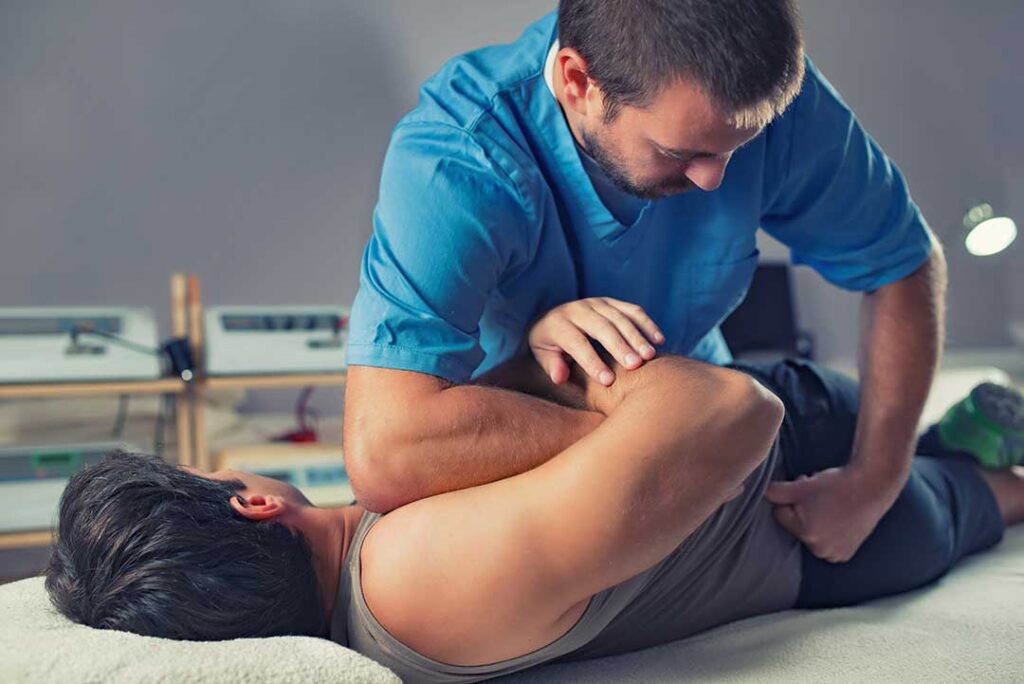 A senior adult receiving a gentle chiropractic adjustment while seated in a comfortable clinic setting.