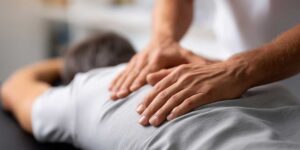 A person sitting in a calm clinic setting talking with a health professional about well-being and comfort.